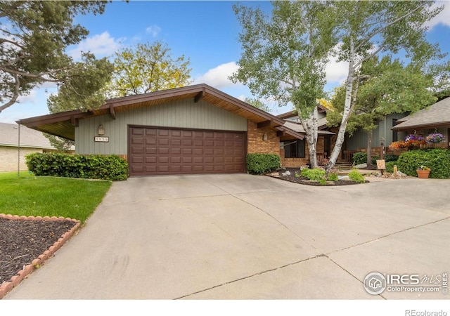 4456 W Pioneer Dr, Greeley, CO 80634 - mid-century home with a garage, driveway, and a front yard