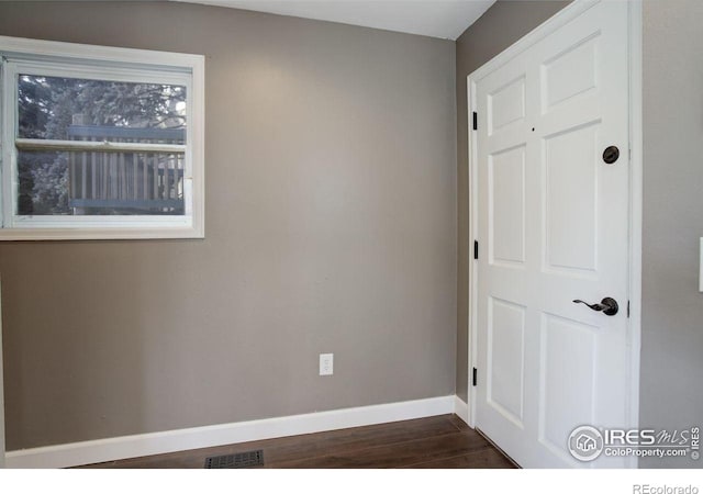 400 Emery St Unit 208, Longmont, CO 80501 - spare room featuring dark wood finished floors and baseboards