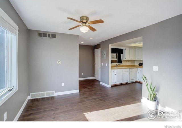 400 Emery St Unit 208, Longmont, CO 80501 - unfurnished living room with a ceiling fan, dark wood finished floors, baseboards, a sink, and plenty of natural light