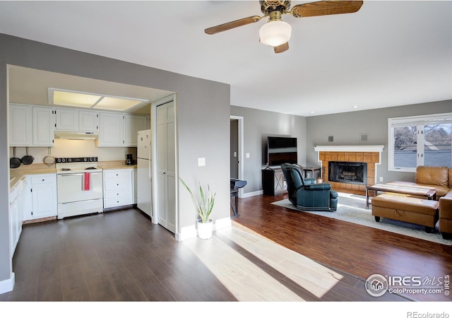 400 Emery St Unit 208, Longmont, CO 80501 - kitchen with white appliances, under cabinet range hood, light countertops, white cabinets, and dark wood-style floors