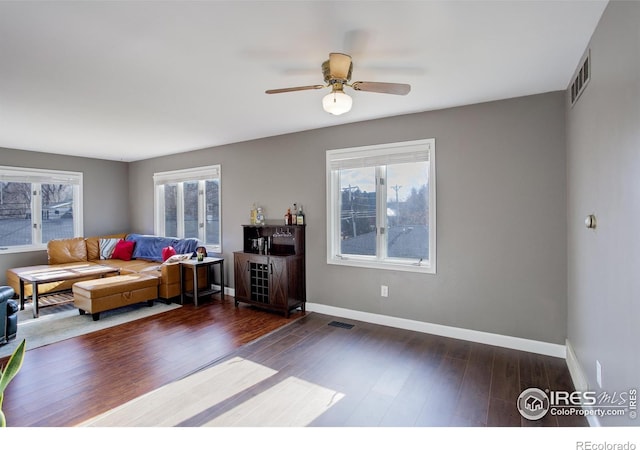 400 Emery St Unit 208, Longmont, CO 80501 - living room featuring plenty of natural light, baseboards, and wood finished floors