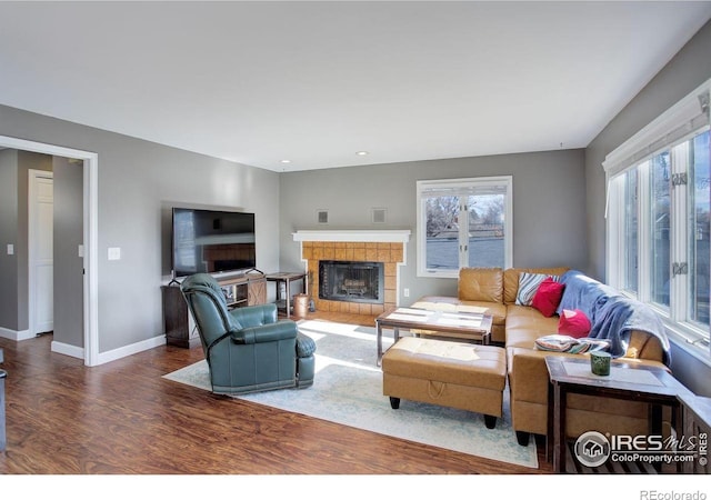 400 Emery St Unit 208, Longmont, CO 80501 - living area with a fireplace, wood finished floors, baseboards, and recessed lighting