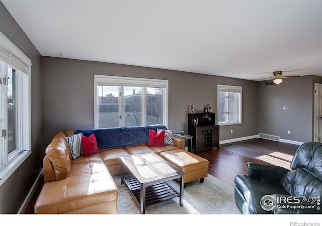 400 Emery St Unit 208, Longmont, CO 80501 - living room featuring wood finished floors, plenty of natural light, baseboards, and a ceiling fan