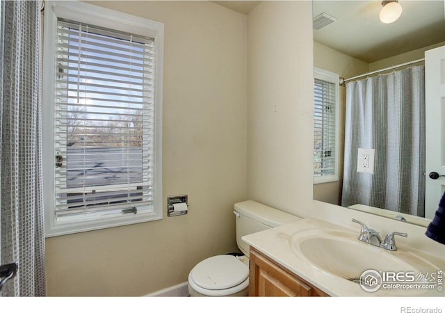 400 Emery St Unit 208, Longmont, CO 80501 - bathroom with toilet, vanity, and baseboards