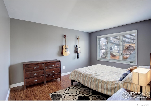 400 Emery St Unit 208, Longmont, CO 80501 - bedroom with baseboards and wood finished floors