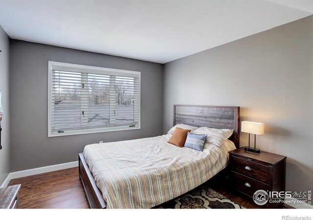400 Emery St Unit 208, Longmont, CO 80501 - bedroom featuring wood finished floors and baseboards