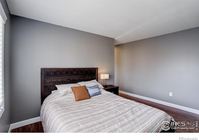 400 Emery St Unit 208, Longmont, CO 80501 - bedroom with baseboards and wood finished floors