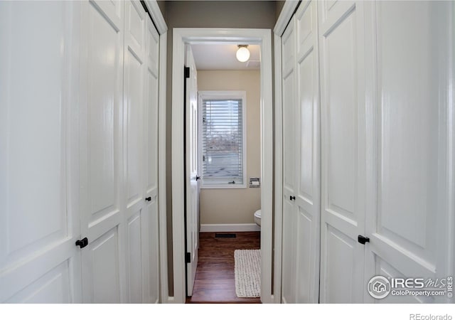 400 Emery St Unit 208, Longmont, CO 80501 - corridor featuring dark wood-style flooring and baseboards
