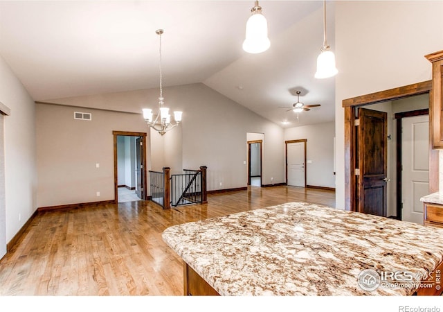 3570 Saguaro Dr, Loveland, CO 80537 - kitchen with vaulted ceiling, light wood-style floors, a ceiling fan, decorative light fixtures, and baseboards