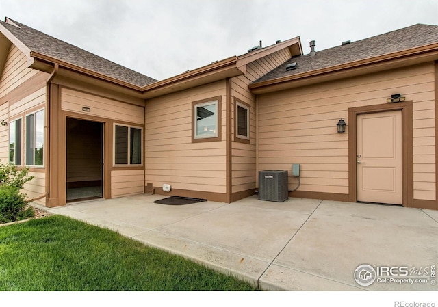 3570 Saguaro Dr, Loveland, CO 80537 - property entrance featuring a patio area, central AC, and roof with shingles