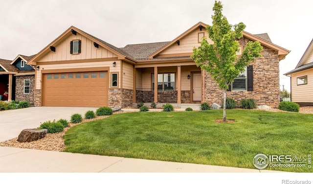 3570 Saguaro Dr, Loveland, CO 80537 - craftsman-style home featuring stone siding, an attached garage, covered porch, a front yard, and concrete driveway