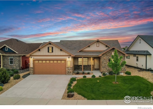 3570 Saguaro Dr, Loveland, CO 80537 - craftsman-style house with stone siding, an attached garage, driveway, and a yard