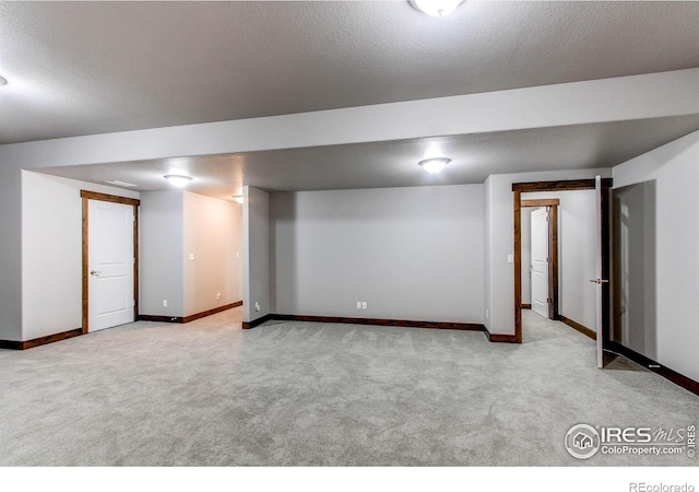 3570 Saguaro Dr, Loveland, CO 80537 - finished below grade area featuring light carpet, baseboards, and a textured ceiling