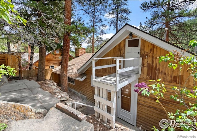 2459 W US Highway 34, Drake, CO 80515 - view of side of home featuring a chimney and a shingled roof
