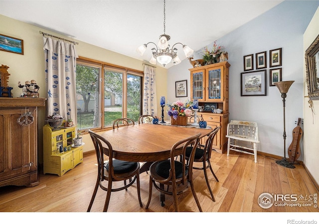 4601 N Sunshine Ct, Loveland, CO 80537 - dining space with a chandelier, light wood-style floors, lofted ceiling, and baseboards