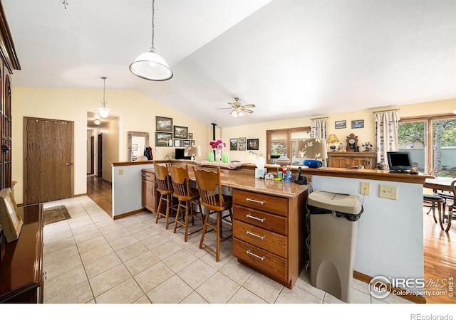4601 N Sunshine Ct, Loveland, CO 80537 - kitchen with open floor plan, healthy amount of natural light, a ceiling fan, vaulted ceiling, and a desk