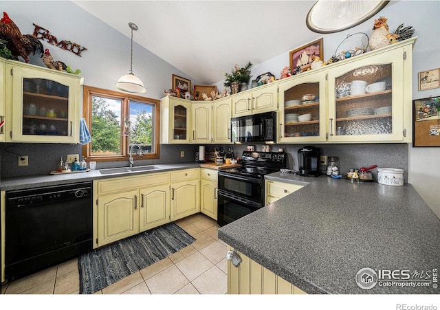 4601 N Sunshine Ct, Loveland, CO 80537 - kitchen featuring black appliances, a sink, cream cabinets, vaulted ceiling, and dark countertops