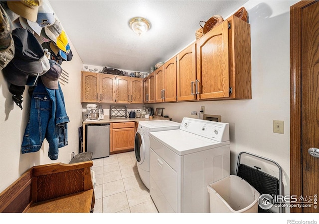 4601 N Sunshine Ct, Loveland, CO 80537 - washroom with cabinet space, washing machine and dryer, and light tile patterned floors