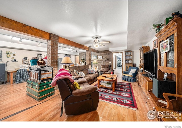4601 N Sunshine Ct, Loveland, CO 80537 - living area with ornate columns, wood finished floors, a ceiling fan, and beam ceiling