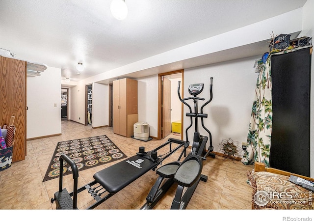 4601 N Sunshine Ct, Loveland, CO 80537 - workout room with baseboards and light tile patterned floors