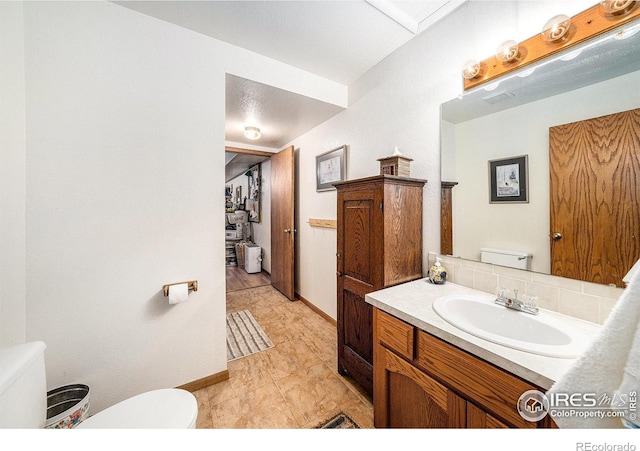 4601 N Sunshine Ct, Loveland, CO 80537 - bathroom with toilet, vanity, and baseboards