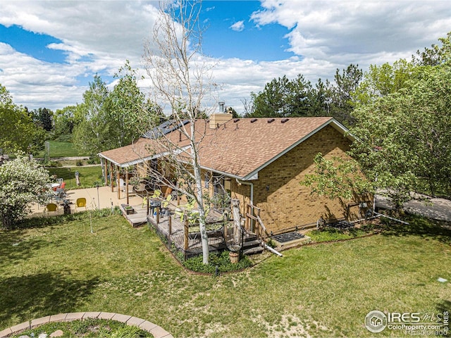 4601 N Sunshine Ct, Loveland, CO 80537 - rear view of property with a patio area, roof with shingles, and brick siding
