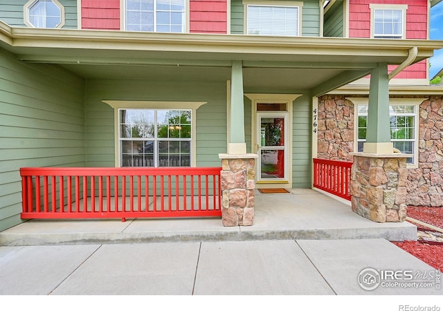 4764 Maggie Ct, Loveland, CO 80537 - property entrance featuring a porch and stone siding