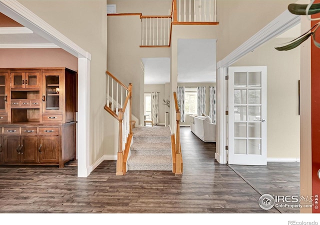 4764 Maggie Ct, Loveland, CO 80537 - foyer with dark wood-style flooring, stairway, baseboards, french doors, and a towering ceiling
