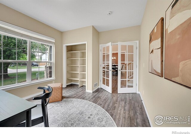 4764 Maggie Ct, Loveland, CO 80537 - unfurnished office with french doors, baseboards, and wood finished floors