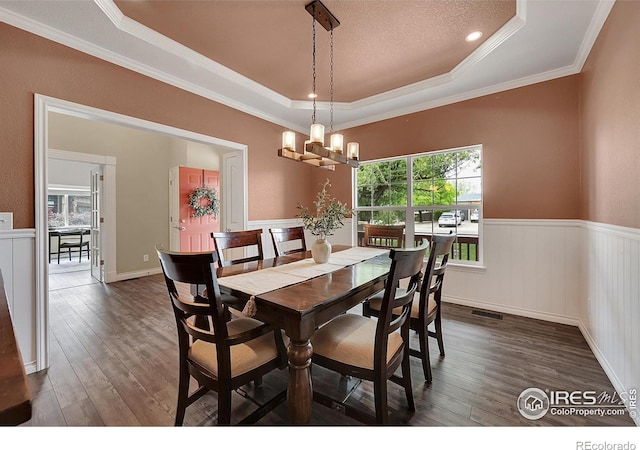 4764 Maggie Ct, Loveland, CO 80537 - dining area with dark wood finished floors, a wainscoted wall, a chandelier, ornamental molding, and a raised ceiling