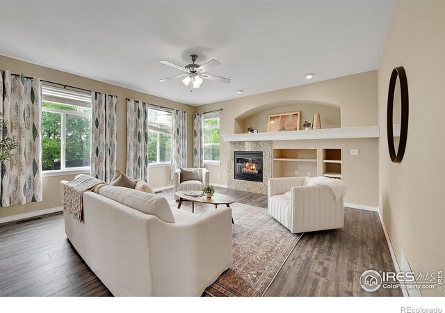 4764 Maggie Ct, Loveland, CO 80537 - living area featuring baseboards, healthy amount of natural light, a tiled fireplace, and recessed lighting