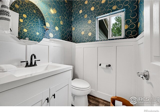4764 Maggie Ct, Loveland, CO 80537 - bathroom with a decorative wall, wallpapered walls, wood finished floors, toilet, and wainscoting