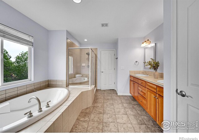 4764 Maggie Ct, Loveland, CO 80537 - full bath featuring a garden tub, a shower stall, double vanity, and baseboards