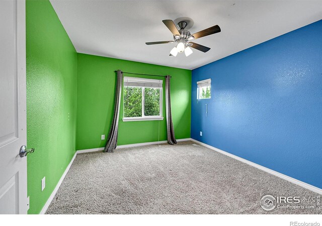 4764 Maggie Ct, Loveland, CO 80537 - unfurnished room featuring baseboards, ceiling fan, carpet flooring, and a textured wall