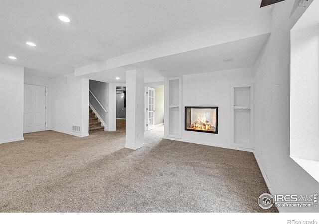 4764 Maggie Ct, Loveland, CO 80537 - unfurnished living room featuring recessed lighting, stairway, carpet flooring, a multi sided fireplace, and baseboards