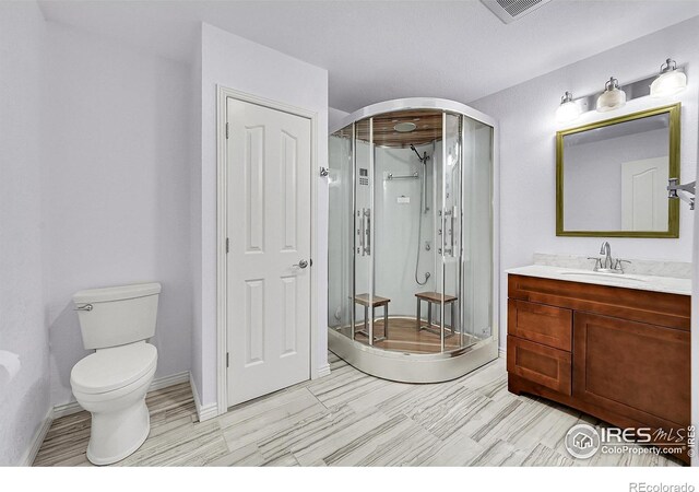 4764 Maggie Ct, Loveland, CO 80537 - bathroom with vanity, a stall shower, toilet, and baseboards