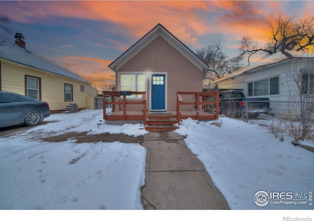 513 N 2nd Ave, Sterling, CO 80751 - view of front facade with a deck and stucco siding