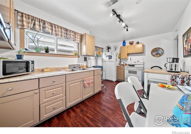 513 N 2nd Ave, Sterling, CO 80751 - kitchen featuring white appliances, a sink, dark wood finished floors, light countertops, and rail lighting