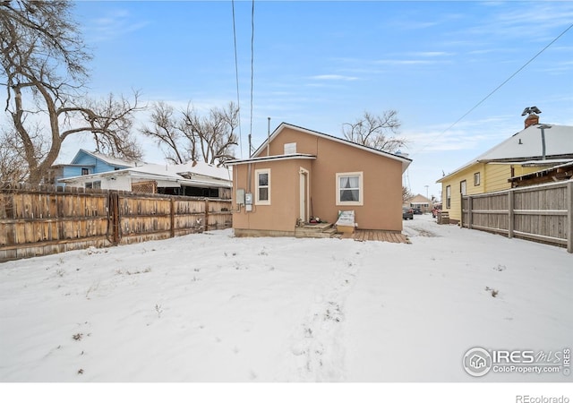513 N 2nd Ave, Sterling, CO 80751 - snow covered property with stucco siding