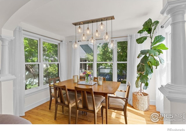 1133 Mapleton Ave, Boulder, CO 80304 - dining space featuring ornate columns, light wood-style floors, and baseboards