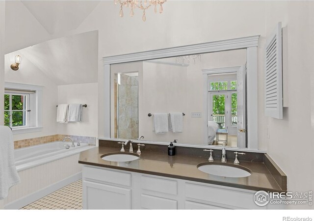 1133 Mapleton Ave, Boulder, CO 80304 - ensuite bathroom featuring a garden tub, double vanity, and vaulted ceiling