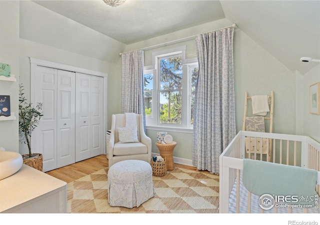 1133 Mapleton Ave, Boulder, CO 80304 - bedroom featuring vaulted ceiling, wood finished floors, a closet, and a crib