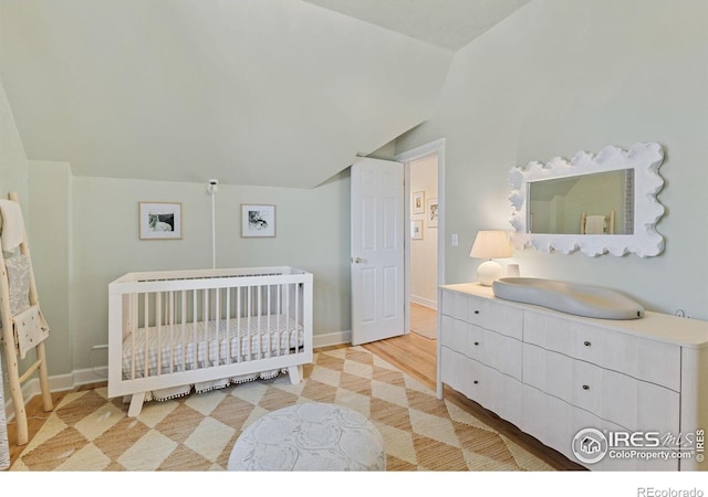 1133 Mapleton Ave, Boulder, CO 80304 - bedroom with lofted ceiling, baseboards, and a crib