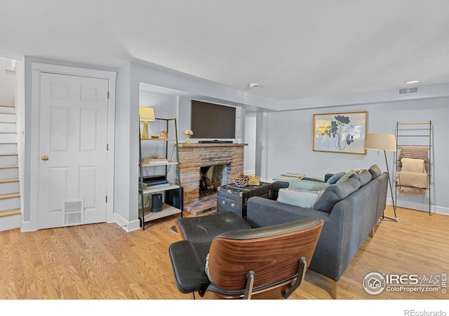 1133 Mapleton Ave, Boulder, CO 80304 - living area featuring stairs, wood finished floors, a fireplace, and baseboards