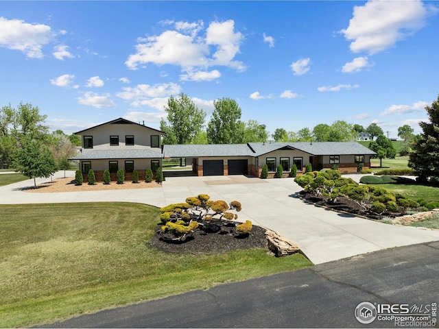 1119 Wrangler Way, Loveland, CO 80537 - view of front of property with an attached garage, concrete driveway, and a front yard