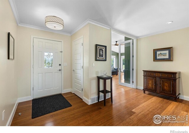 1119 Wrangler Way, Loveland, CO 80537 - entryway featuring wood finished floors, crown molding, a ceiling fan, and baseboards