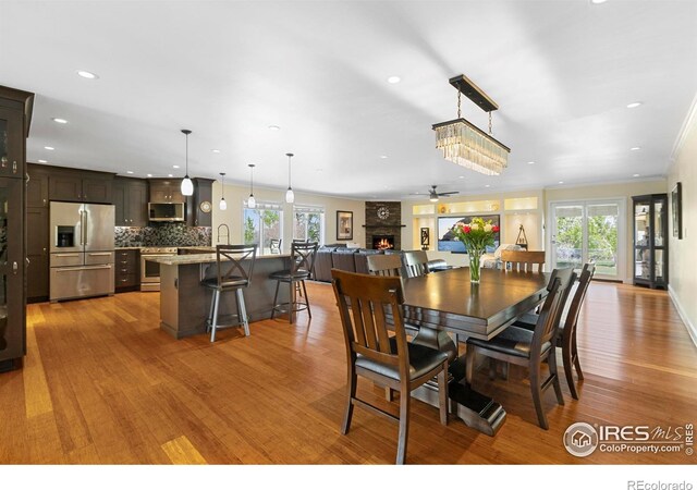 1119 Wrangler Way, Loveland, CO 80537 - dining room with wood finished floors, recessed lighting, and a ceiling fan