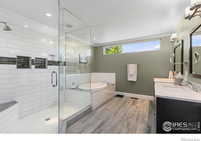 1119 Wrangler Way, Loveland, CO 80537 - bathroom with crown molding, a shower stall, a bath, vanity, and baseboards