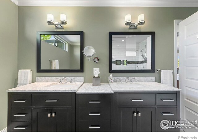 1119 Wrangler Way, Loveland, CO 80537 - bathroom featuring double vanity, crown molding, and tiled shower