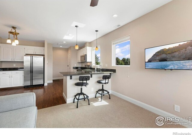 1119 Wrangler Way, Loveland, CO 80537 - kitchen featuring appliances with stainless steel finishes, dark countertops, white cabinetry, and recessed lighting